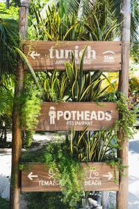 a sign for the restrooms at a resort at Tunich Jungle Cabañas in Tulum
