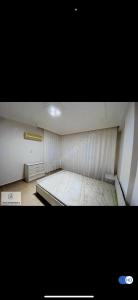 an empty room with a bed in a room at Murat Baris Residence in Alanya