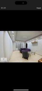 a room with a purple couch and a table at Murat Baris Residence in Alanya