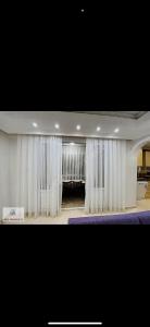a large room with white curtains and a stage at Murat Baris Residence in Alanya