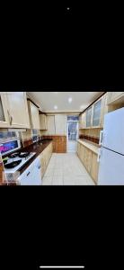 a large kitchen with white appliances and a window at Murat Baris Residence in Alanya