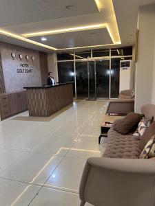 a man standing at a counter in a lobby at Hotel Golf Coast in Kinshasa +38 photos