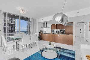 a living room and kitchen with a table and chairs at Luxurious Condo at ICON with Views in Miami