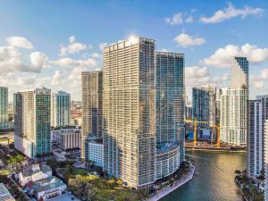 a city skyline with tall buildings and a river at Luxurious Condo at ICON with Views in Miami