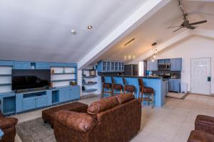 a living room with blue cabinets and a couch at Tropical Suites Hotel in Bocas Town