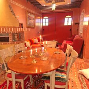 a dining room with a wooden table with candles on it at apparemment de luxe in Safi +35 photos