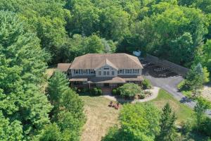 an aerial view of a large house in the woods at Moondance Ridge Suites in New Paltz
