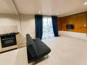 a living room with a couch and a stove at Appartement cosy in Fort-de-France