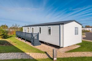 a white tiny house with a porch at Lisa Marie-Luxury Caravan-Seton Sands-8 Berth in Port Seton