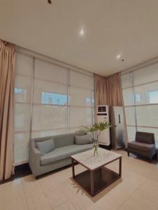 a living room with a couch and a table at Centrio Tower Studio Unit 19-03 in Cagayan de Oro