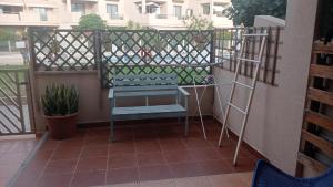 a balcony with a bench and a ladder at Apartamento en La Tejita-El Médano. Familia Vilmar in Granadilla de Abona