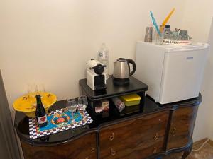 a dresser with a cake on top of it next to a refrigerator at CASA di Pi in Bologna