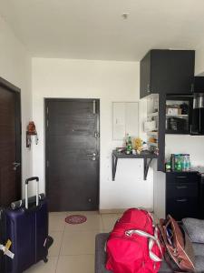 a living room with luggage and a red bag at Ranga Vila’s on ECR in Chennai
