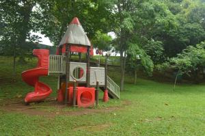 a playground in a park with a play structure at Totumas Lodge in Panama City