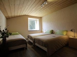 a bedroom with two beds and a window at Charmante maison en pierre près du Lac de Lavalette, idéale pour randos, nature et détente totale - FR-1-582-43 in Saint-Jeures