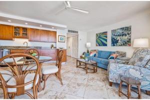 a living room with a couch and a table at KIHEI BEACH, #406^ condo in Kihei