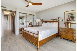 a bedroom with a bed and a dresser and a mirror at WAILEA ELUA, #1305^ condo in Wailea