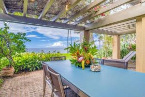 a patio with a blue table and chairs and the ocean at WAILEA ELUA, #1305^ condo in Wailea +59 photos