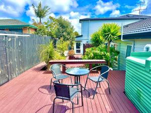 a patio with a table and chairs on a deck at Albany Modern Private 2 bedroom 2 bathroom with Full Kitchen Netflix in Auckland