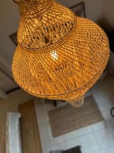 a straw hat is hanging from a ceiling at BUNGALOW F2 Atypical local style in Faaa