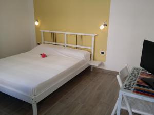 a bedroom with a bed with a red flower on it at Villa Felice in Porto Cesareo
