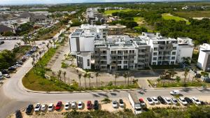 an aerial view of a large white building with parked cars at Coral Bay 2 bedroom @ Hard Rock Hotel Punta Cana in Punta Cana