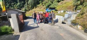 a group of people standing on the side of a road at Yuven House in Darjeeling