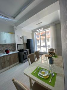 a kitchen and dining room with a table and chairs at Elizavetta in Bishkek +20 photos