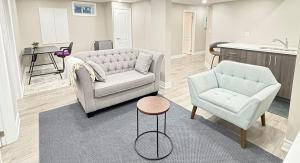 un soggiorno con due sedie, un divano e un tavolo di Cozy 1.5 Guest-Suite a Aurora