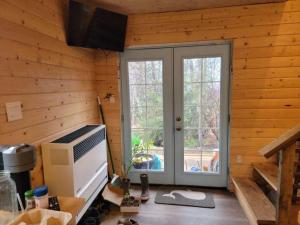 a kitchen with a window and a door in a room at Birch Tree Cabins in Homer