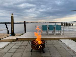 a fire pit on a dock next to a body of water at Waterfront Home with Private Beach, Stunning Views in Middle River