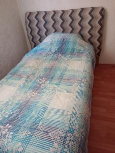 a bed with a quilt on it in a room at siberia 166 departamento 211 in Mexico City