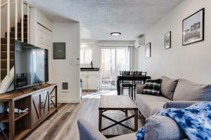 a living room with a couch and a flat screen tv at Getaway near UO, Autzen Stadium, Amazon Park # 3 in Eugene +22 photos