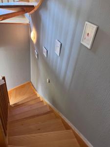 a staircase in a room with wooden floors and lights at Wahnbacher Mühle in Wadern