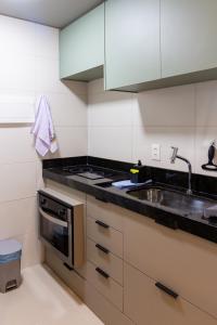 a kitchen with a sink and a stove at Lindo apartamento no melhor do Recife in Recife