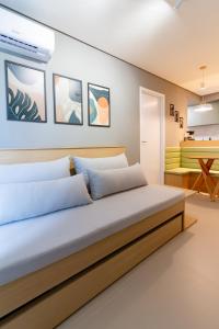 a bedroom with a large bed and a table at Lindo apartamento no melhor do Recife in Recife