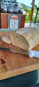 a loaf of bread sitting on top of a cutting board at Balelangga Bed & Breakfast in Sapit