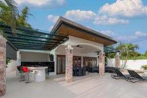 a house with a patio with a roof at Orchid Paradise Homes OPV 210 in Hua Hin