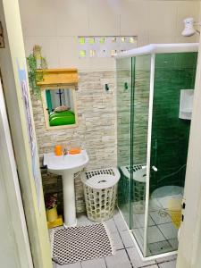 a bathroom with a sink and a glass shower at Chalés Caiçara Serrambi in Porto De Galinhas