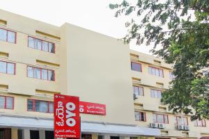 a red sign in front of a building at Collection O Hotel Happy Stay Near Hyderabad Central in Ameerpet