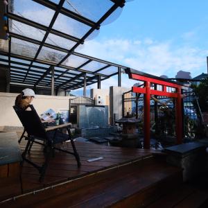 a woman sitting in a chair on a patio at Love's World B&B in Jian