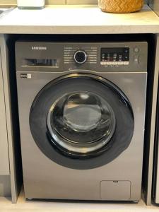 a washing machine sitting on top of a counter at 3- Lovely 1 Bed Apartment extra sofa bed-West Midlands 
