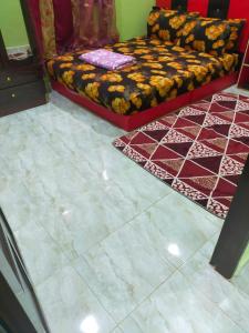 uma sala de estar com uma cama e pisos em azulejo em ABAH HOMESTAY, MANIR, KUALA TERENGGANU (HOMESTAY A) em Kuala Terengganu