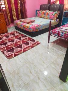 uma sala de estar com uma cama e um sofá em ABAH HOMESTAY, MANIR, KUALA TERENGGANU (HOMESTAY A) em Kuala Terengganu