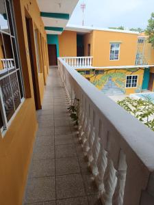 een gang van een gebouw met een balkon bij Hotel y Restaurante Casa Jardines in San Benito