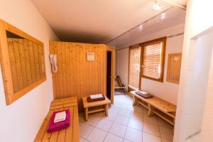 a bathroom with wooden doors and benches in a room at Hôtel du Bourg in Valmorel +61 photos