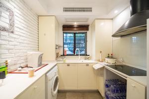 a kitchen with a sink and a washing machine at Shanghai Celebrity Courtyard B&B in Shanghai