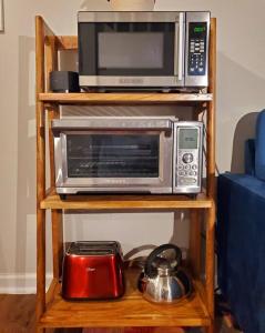 a microwave and a toaster oven on a shelf at Cute tiny-apartment loft near NC State in Raleigh
