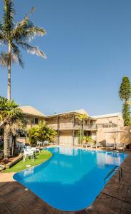 a large blue swimming pool in a resort at Mollymook Shores in Mollymook