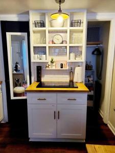 a kitchen with white cabinets and a yellow counter top at Cute tiny-apartment loft near NC State in Raleigh